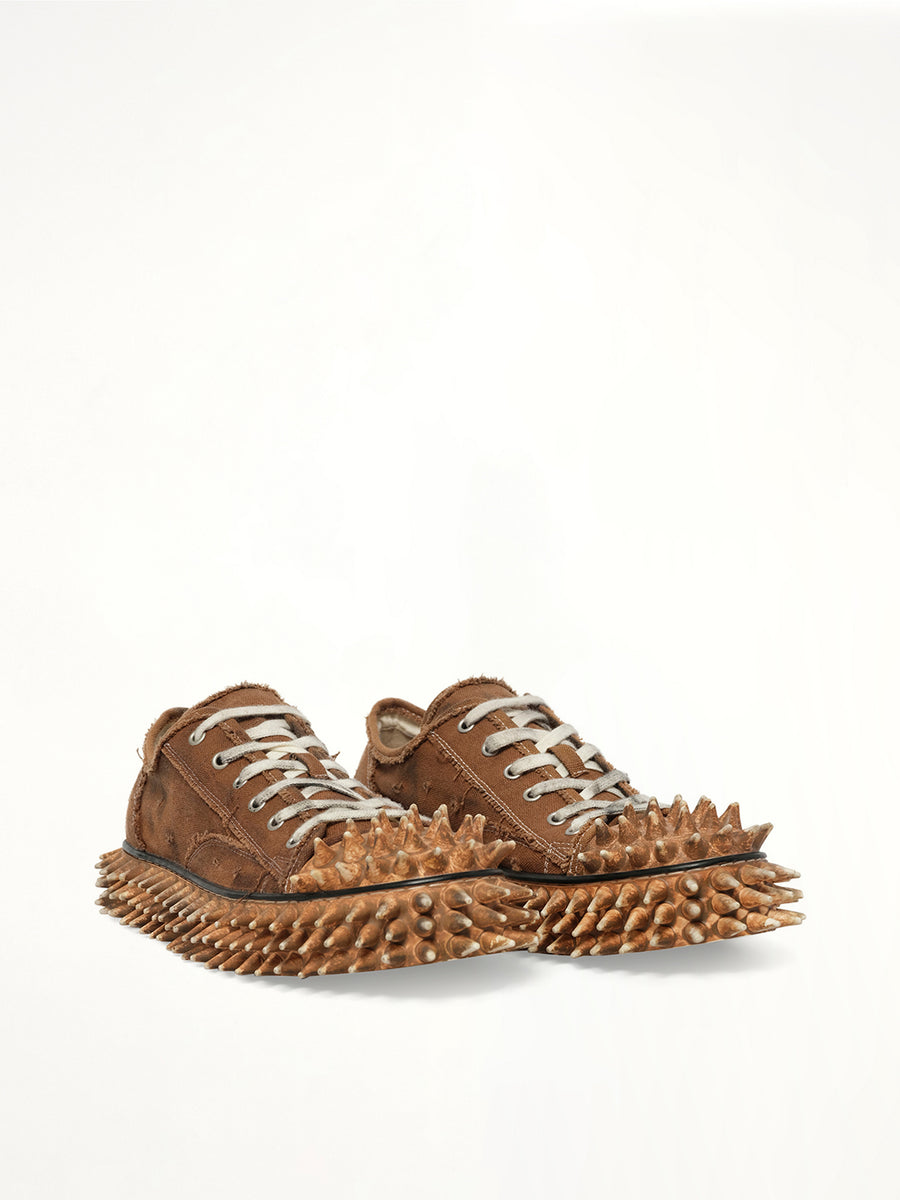 Dirty Spike Toe  Cap Canvas Sneaker in Brown Front View | DOUBLET